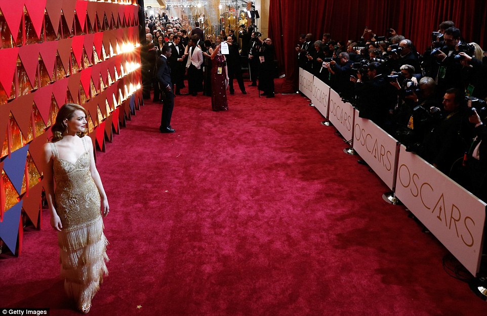 Jessica Biel, Emma Stone, Chrissy Teigen and Dakota Johnson sparkle in metallics as they walk the star-studded Oscars Red Carpet