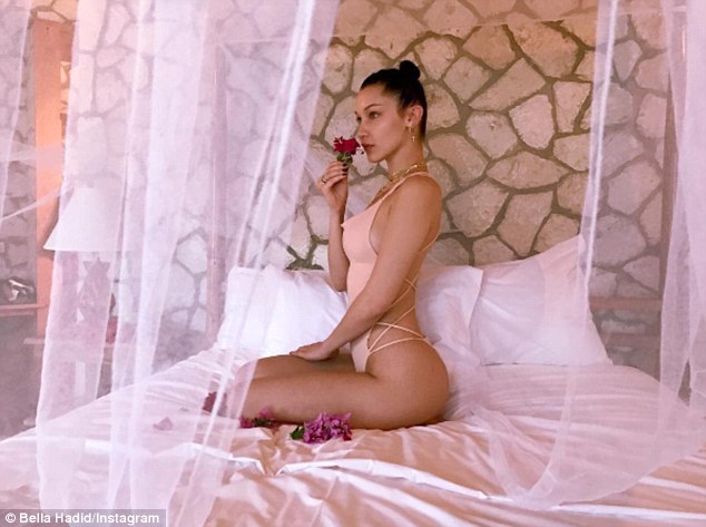 Bella Hadid shares a steamy shot of her herself relaxing in a nude swimsuit as Jamaica getaway comes to an end