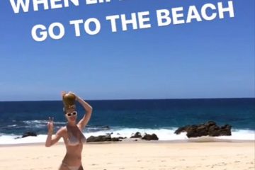 Life’s a beach! Katy Perry cavorts solo on the sand in a skimpy string Bikini with a coconut on her head