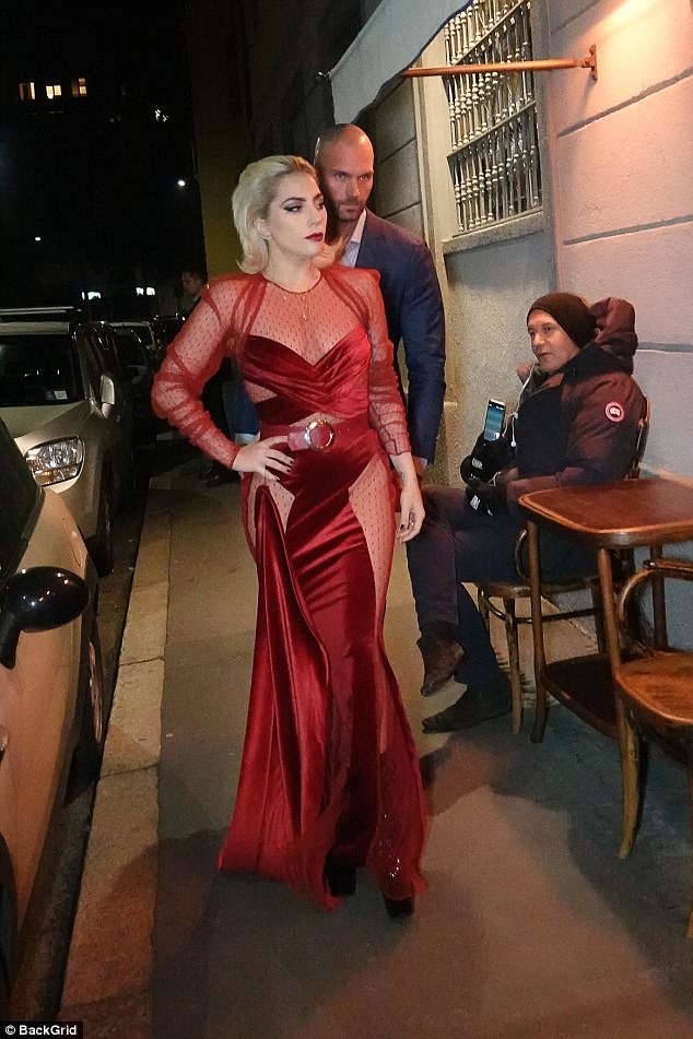 Sizzling Lady Gaga just about protects her modesty in mesh-insert gown as she makes VERY dramatic entrance to dinner in Milan