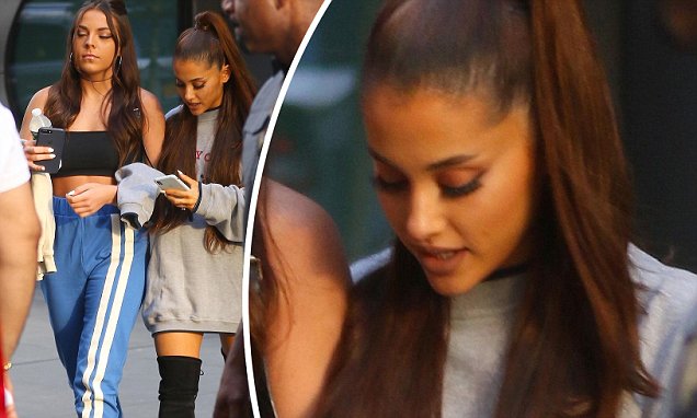 Ariana Grande models thigh high Boots as she steps out with a female pal in NYC