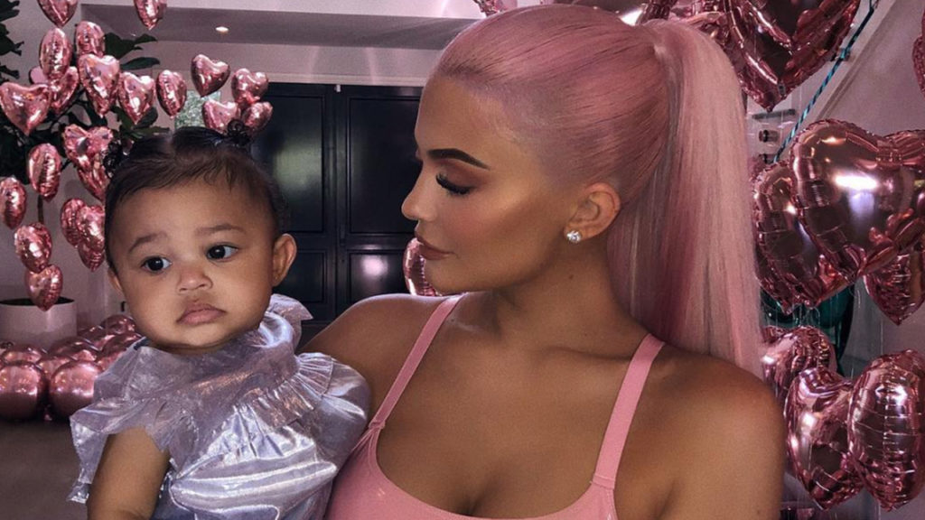 Kylie Jenner poses with a dolled-up Baby Stormi at Kylie X Jordyn Collection launch Party