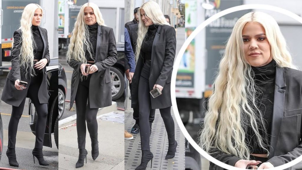 Khloe Kardashian flashes hint of her midriff all Black ensemble with cascading Platinum tresses